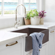 Nantucket Sinks T-FCFS30CB Coffee Brown farmhouse sink in white cabinets with a towel on the apron