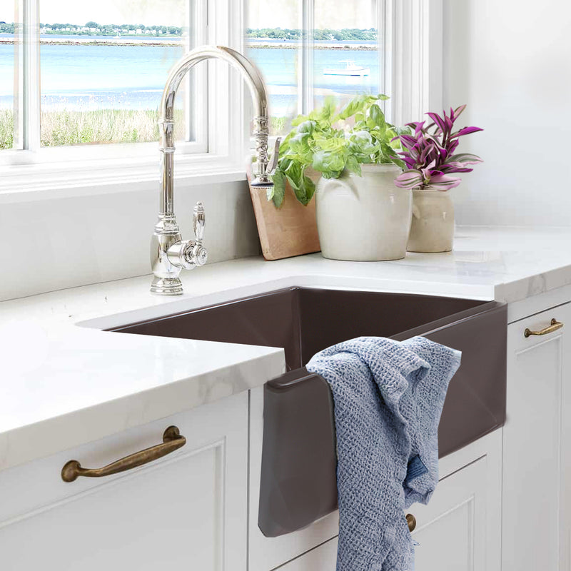 Nantucket Sinks T-FCFS30CB Coffee Brown farmhouse sink in white cabinets with a towel on the apron