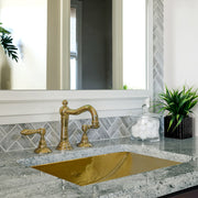 Nantucket Sinks TRB2416-OF brass trough sink undermounted in gray granite with a brass widespread faucet