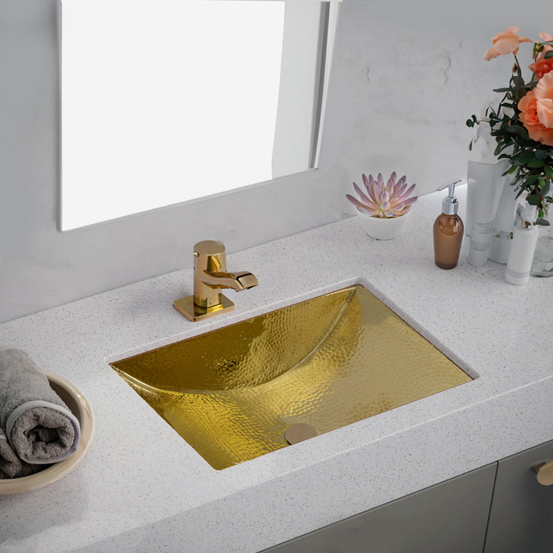 Nantucket Sinks TRB2416-OF brass trough sink in a white quartz vanity top with a brass single-hole faucet