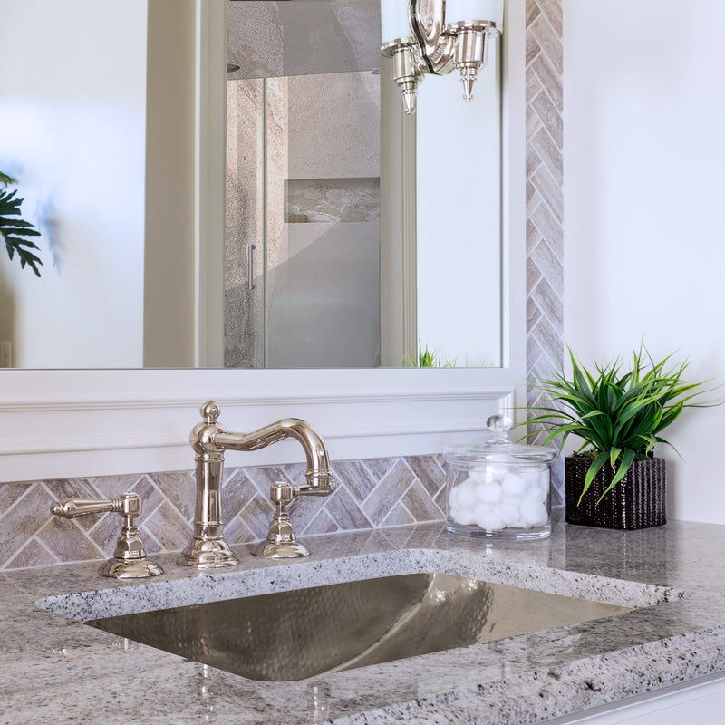 Nantucket Sinks TRS2416 installed in a granite vanity with a bridge faucet