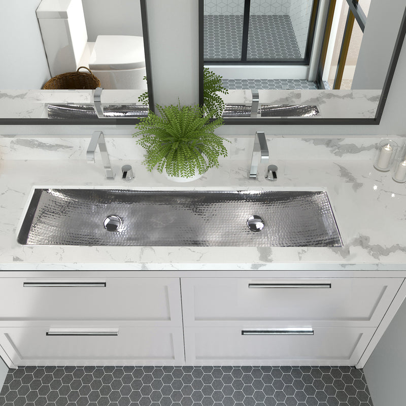 Nantucket Sinks TRS48-OF stainless trough sink with two faucets in a white marble double vanity