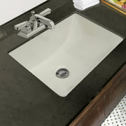 Nantucket Sinks UM-16x11-B bisque undermount sink in a black granite vanity with a centerset faucet