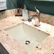 Nantucket Sinks UM-16x11-B bisque undermount sink in a speckled granite vanity with a single-hole faucet
