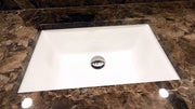 Nantucket Sinks UM-18x13-W white rectangular undermount sink in a brown marble counter