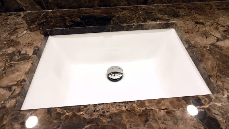 Nantucket Sinks UM-18x13-W white rectangular undermount sink in a brown marble counter
