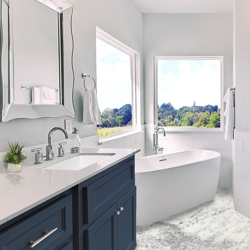 Nantucket Sinks UM-19x11-W white undermount sink in a navy vanity beside a freestanding tub