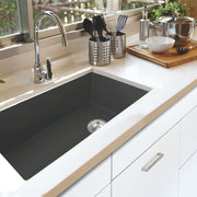 Nantucket Sinks Wellfleet-3419MatteBlack Matte Black single bowl sink undermounted in a white counter with chrome faucet