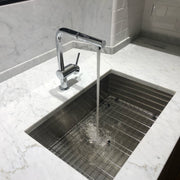 Nantucket Sinks ZR2818-8-16 installed in white marble with a chrome faucet running over the grid