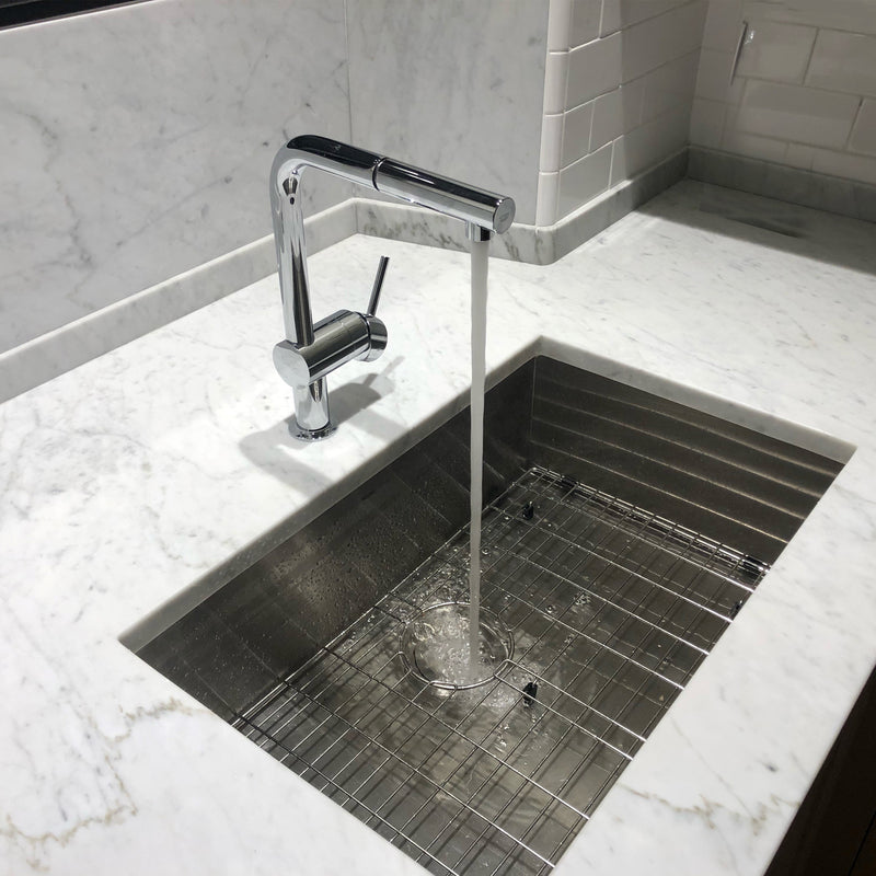Nantucket Sinks ZR2818-8-16 installed in white marble with a chrome faucet running over the grid