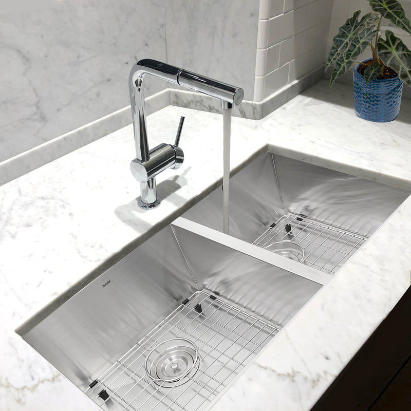 Nantucket Sinks ZR3219-OS-16 installed in white marble with a chrome faucet and grids