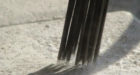 Nineteen needles on rough concrete