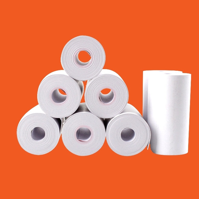 PressurePro thermal printer paper rolls stacked in a pyramid with one roll standing, on an orange background