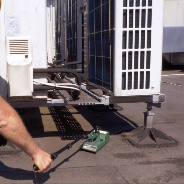 Tramex RWS - Roof and Wall Scanner: Image showing the Tramex RWS device in use for non-destructive testing on a roof surface, equipped with an extension arm for enhanced reach and accuracy.