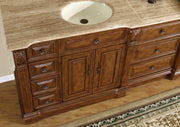 Silkroad Exclusive HYP-0904-T-UIC-95 close-up of the ivory oval sink in the Travertine top and carved corbels