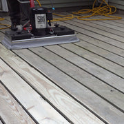 Wooden deck with a power tool and container on top