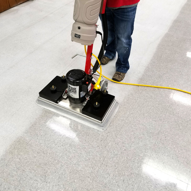 Person using a carpet cleaning machine on a carpeted floor