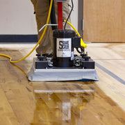 Floor scrubber machine on a wooden floor with 'Square Scrub' branding.