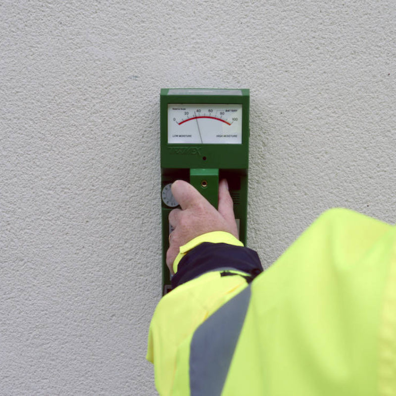 Tramex RWS - Roof and Wall Scanner: Image of the Tramex RWS moisture meter on a flat surface, showcasing its display screen, control buttons, and ergonomic design, designed for detecting moisture levels in roofs and walls.