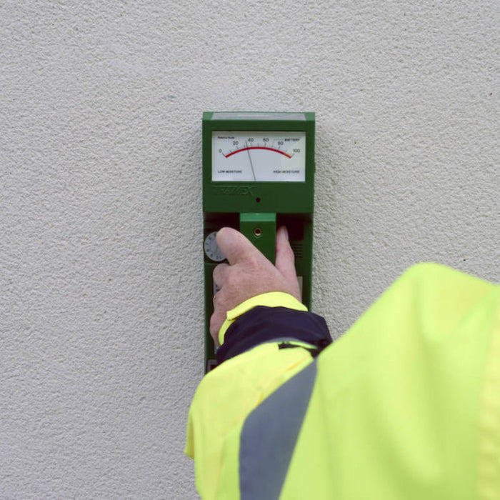 Tramex RWS - Roof and Wall Scanner: Image of the Tramex RWS moisture meter on a flat surface, showcasing its display screen, control buttons, and ergonomic design, designed for detecting moisture levels in roofs and walls.