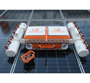 Tucker RTM PRO solar cleaning robot on solar panels with its orange handheld remote