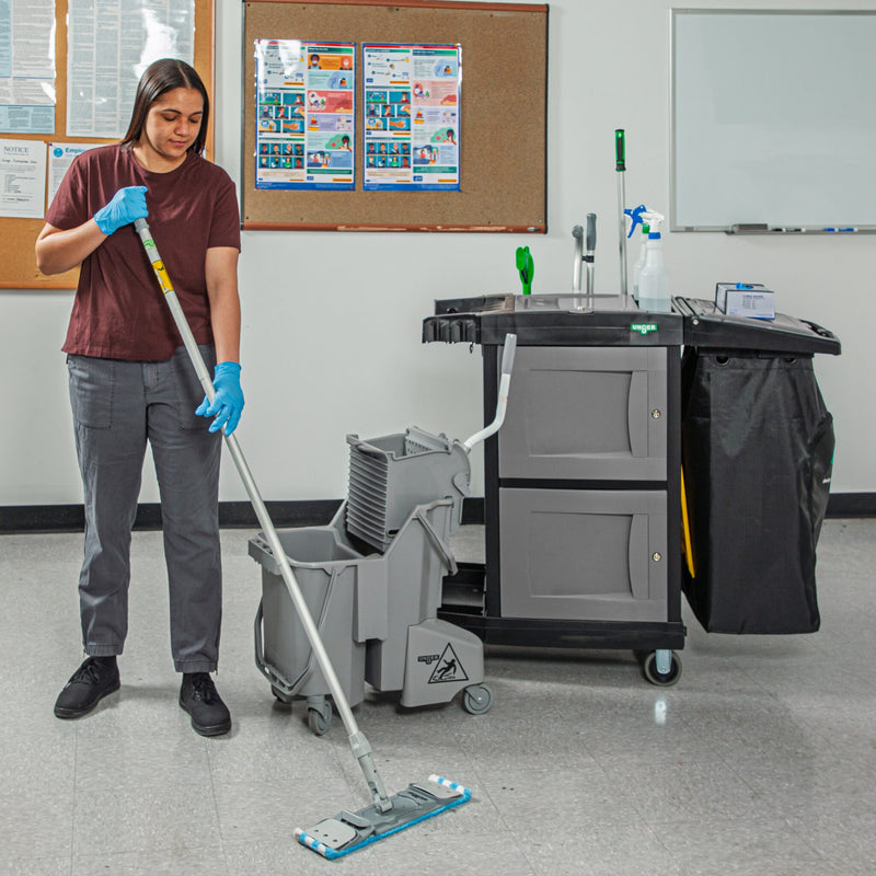 Unger CleanRx Elite Janitorial Cleaning Cart, cart beside a cleaner mopping an office