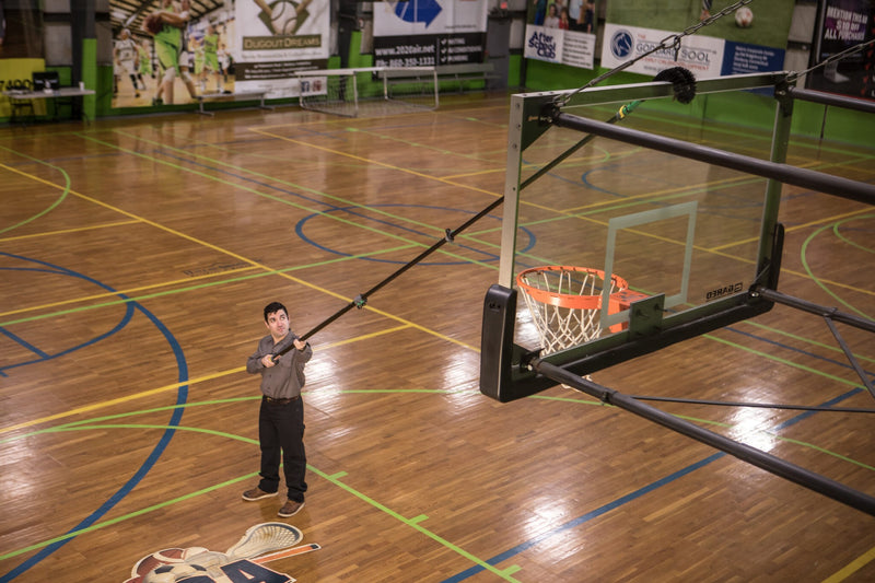 Unger High Access Dusting Kit, dusting a basketball hoop from the floor with a long pole