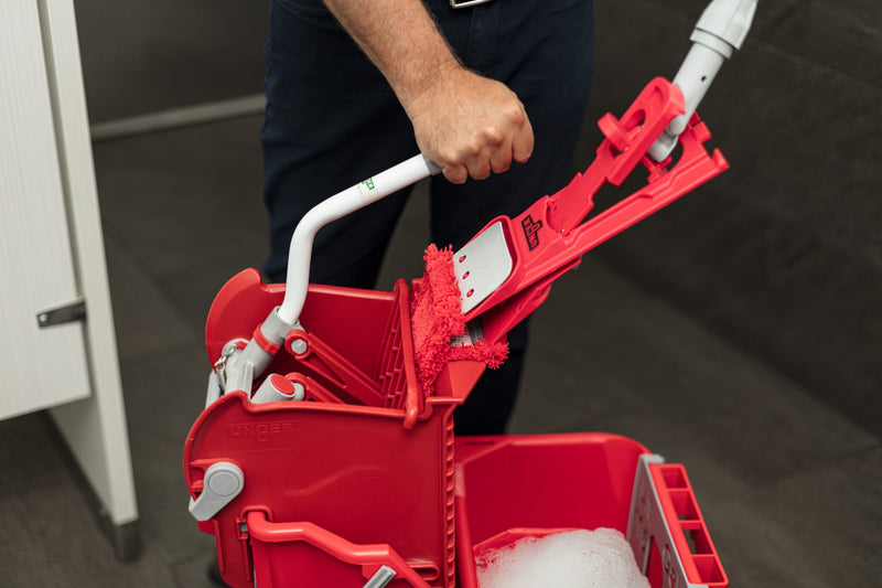 Unger Restroom Complete Mop Pack, lifting the mop from the bucket
