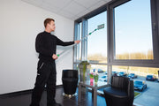 Unger SpeedClean Starter Kit, cleaning a tall office window with the pad holder on a pole