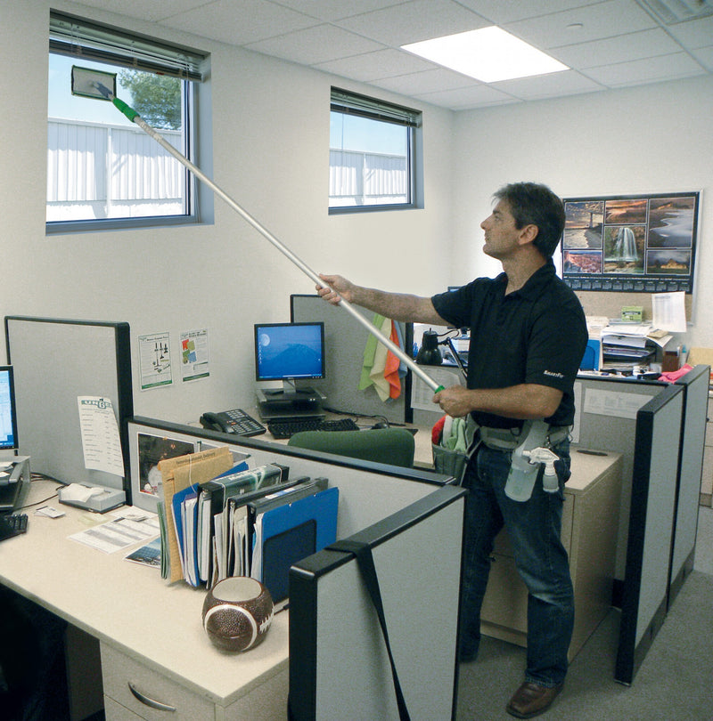 Unger SpeedClean Starter Kit, cleaning a high office partition with the pad holder on a pole