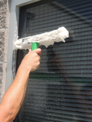 Unger Starter Pro Window Cleaning Kit, scrubbing a window with the strip washer by hand