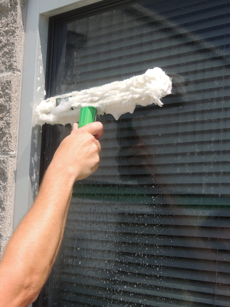 Unger Starter Pro Window Cleaning Kit, scrubbing a window with the strip washer by hand